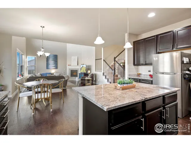 a kitchen with a table chairs and refrigerator