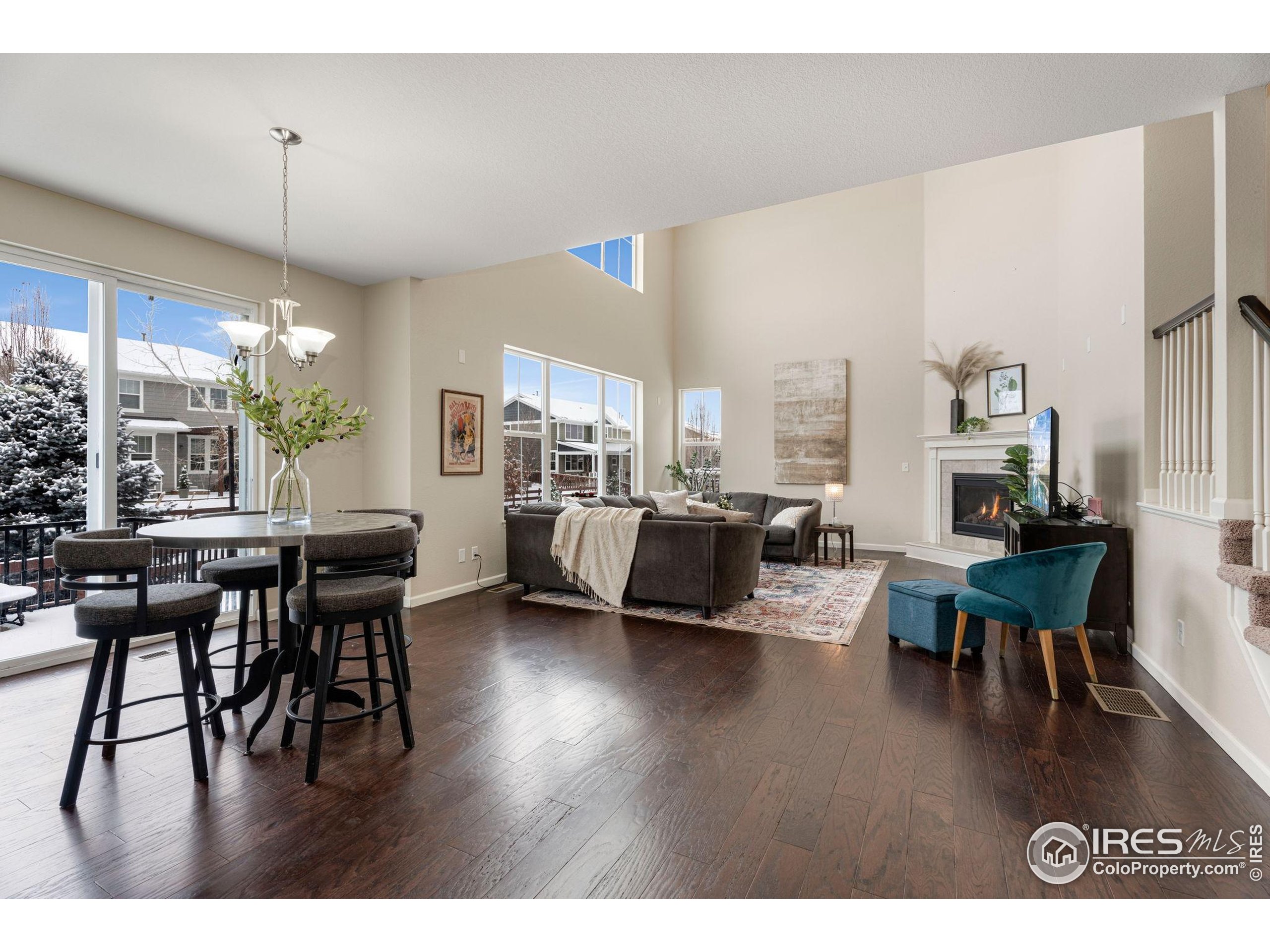6770 Spring Rain Road Timnath, CO 80547 - Photo 13 of 30 a living room with furniture and a wooden floor