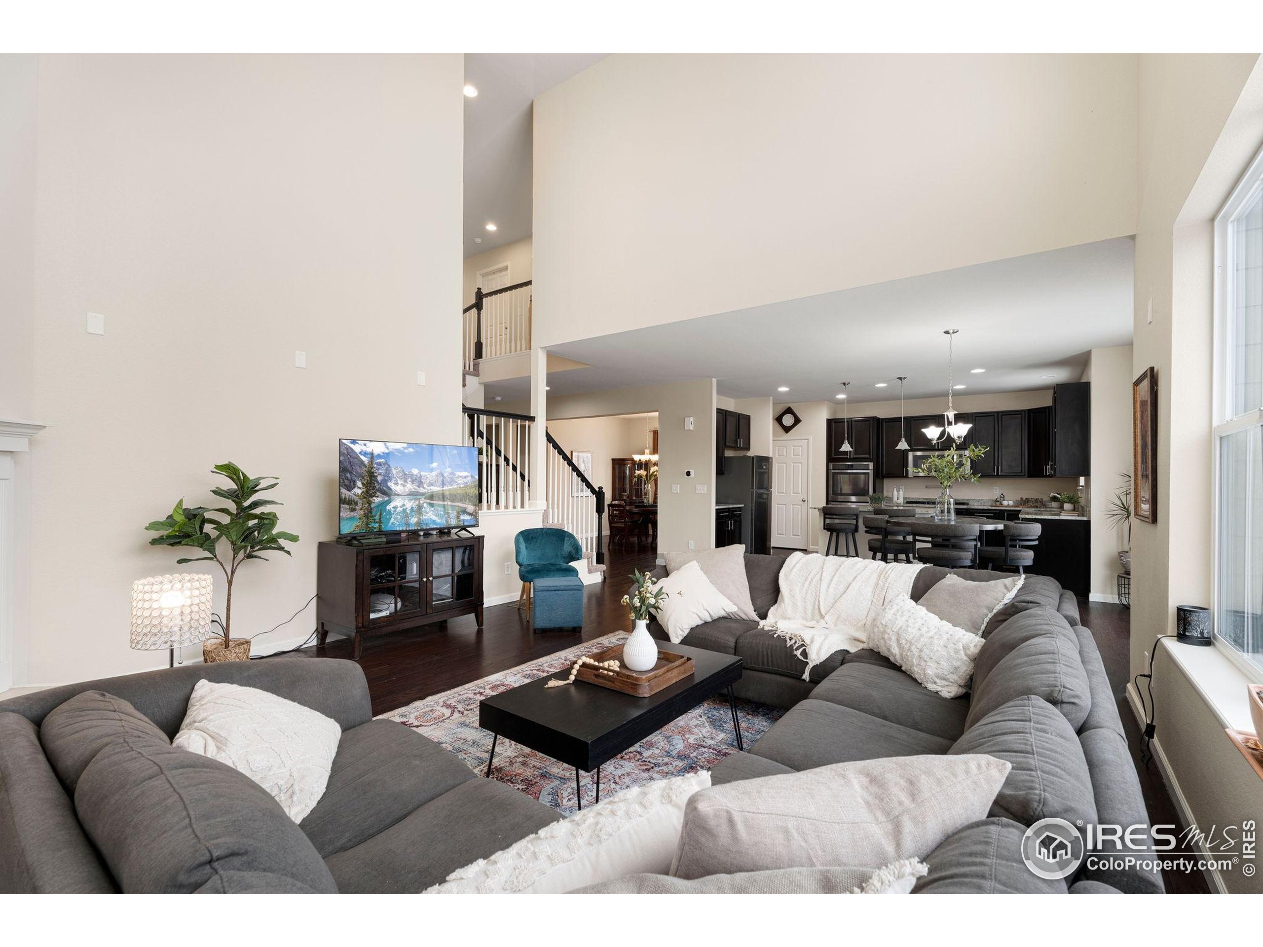6770 Spring Rain Road Timnath, CO 80547 - Photo 14 of 30 a living room with furniture and a fireplace