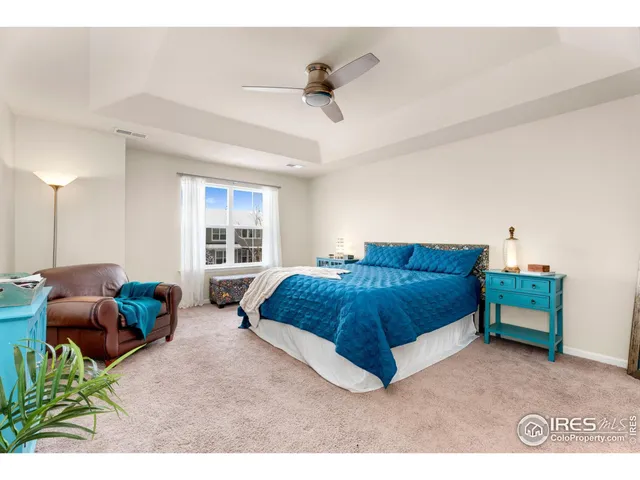 a spacious bedroom with a bed a couch and a window