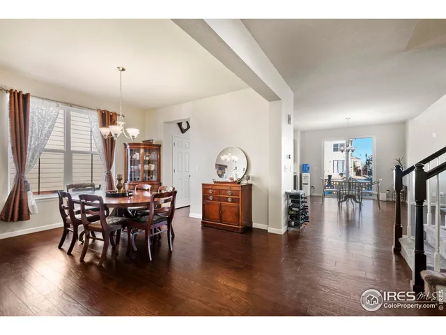 a dining room with furniture and wooden floor