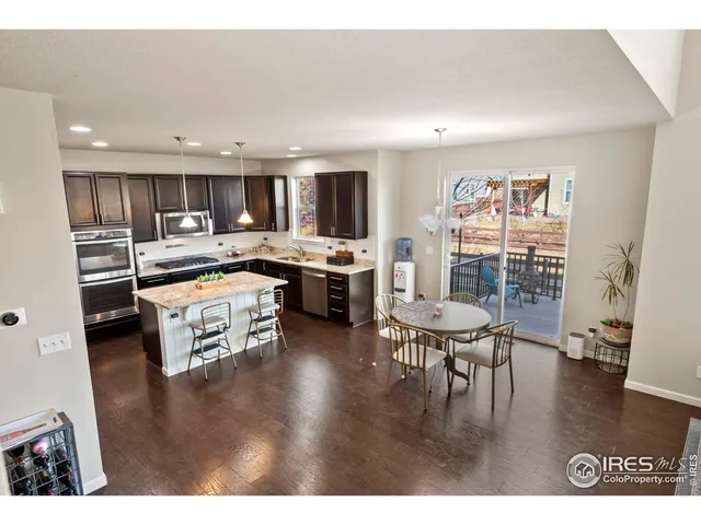 a kitchen with stainless steel appliances granite countertop a stove and a refrigerator