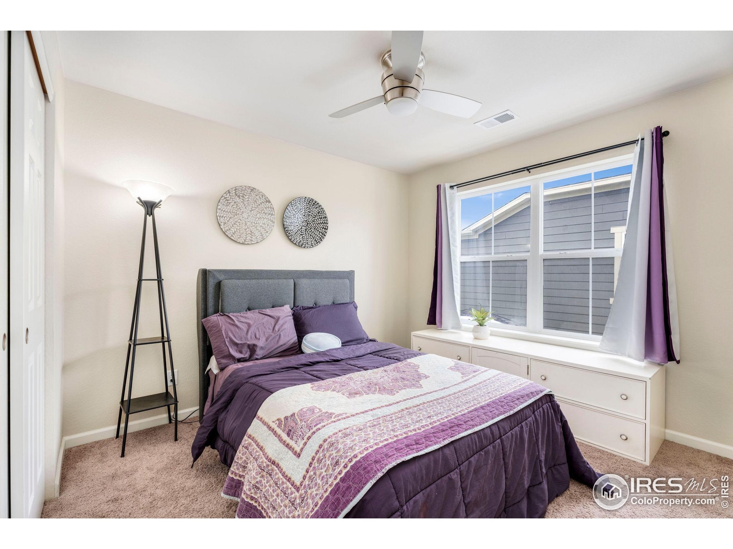 6770 Spring Rain Road Timnath, CO 80547 - Photo 21 of 30 a bedroom with a large bed and a window