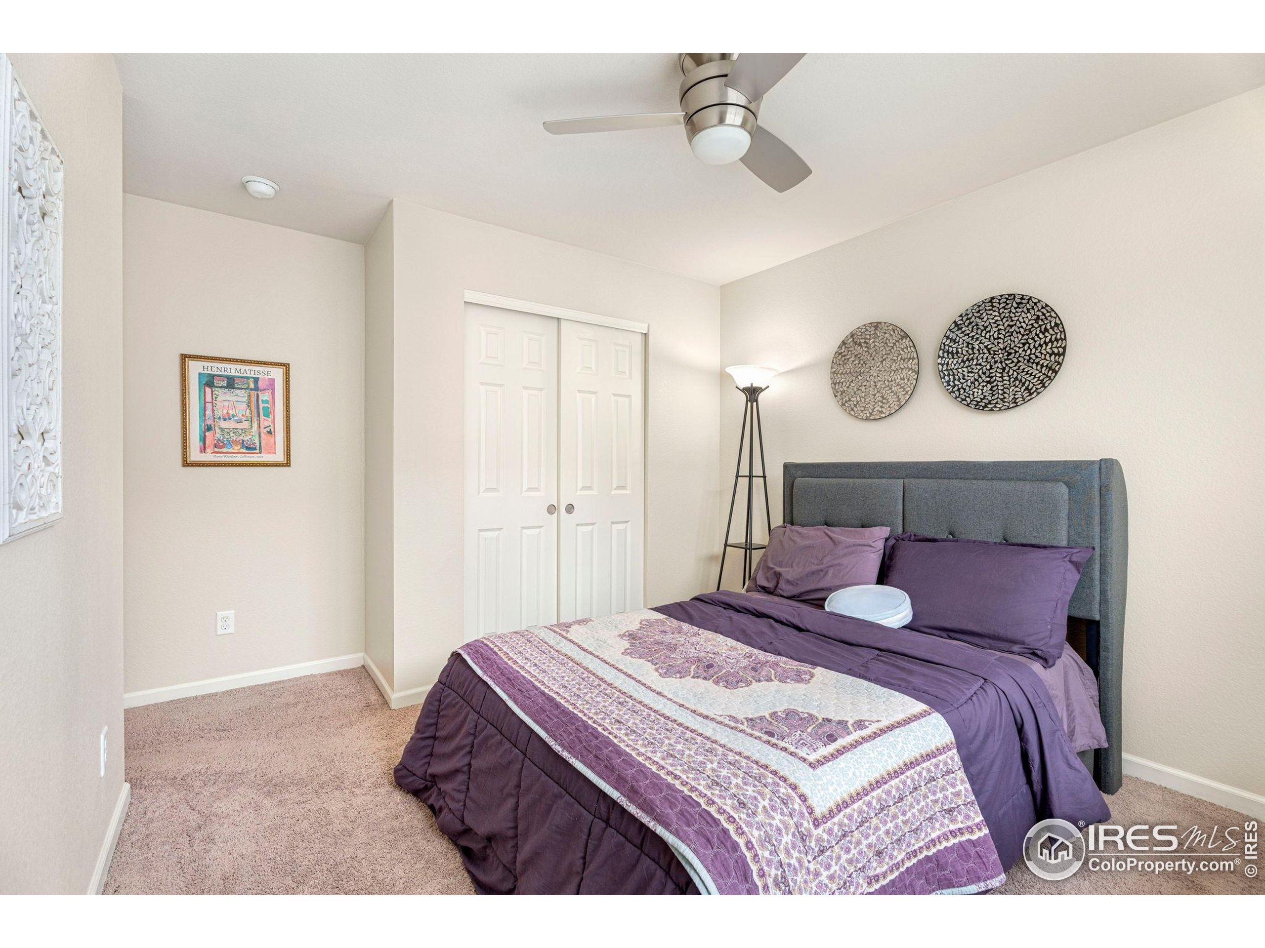 6770 Spring Rain Road Timnath, CO 80547 - Photo 22 of 30 a bedroom with a bed and a chandelier