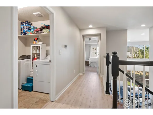 a view of a hallway with wooden floor and windows