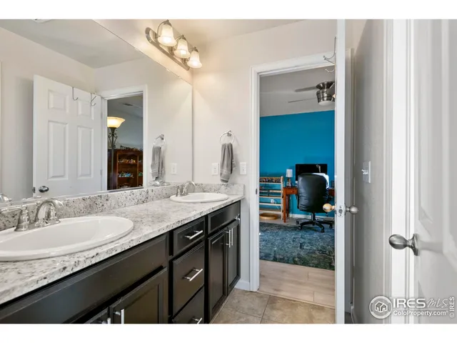 a bathroom with sink granite and a mirror