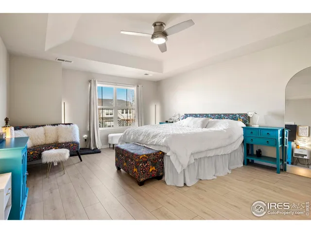 a spacious bedroom with a bed window and a table