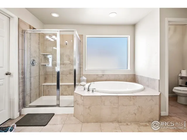 a bathroom with a tub a sink and a shower