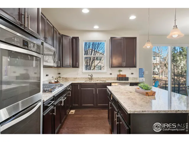 a kitchen with a sink a stove and cabinets