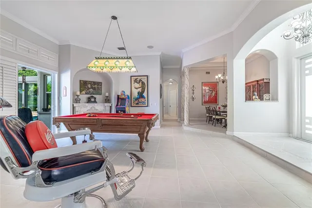 a living room with stainless steel appliances kitchen island granite countertop furniture and a flat screen tv