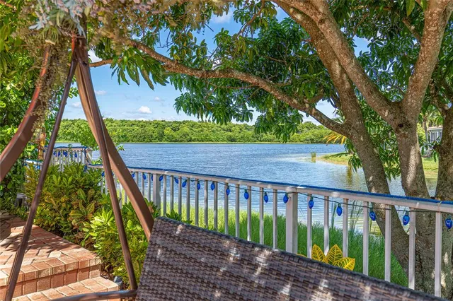 a bed sitting in a spacious bedroom next to a window