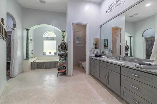 an aerial view of a house with a yard and a fountain