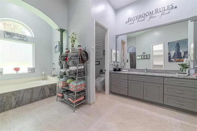 a backyard of a house with table and chairs under an umbrella