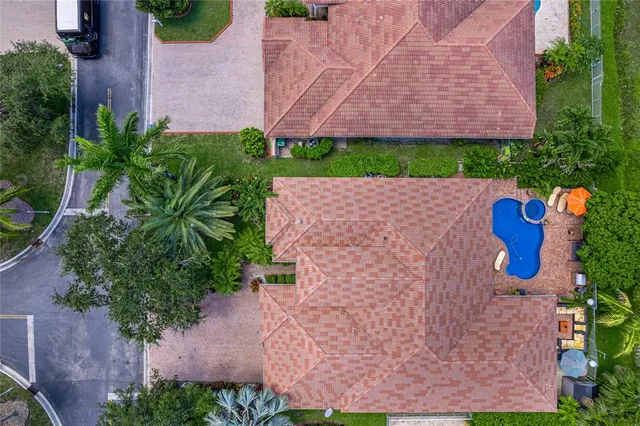 a yellow and red house with a tree in front of it