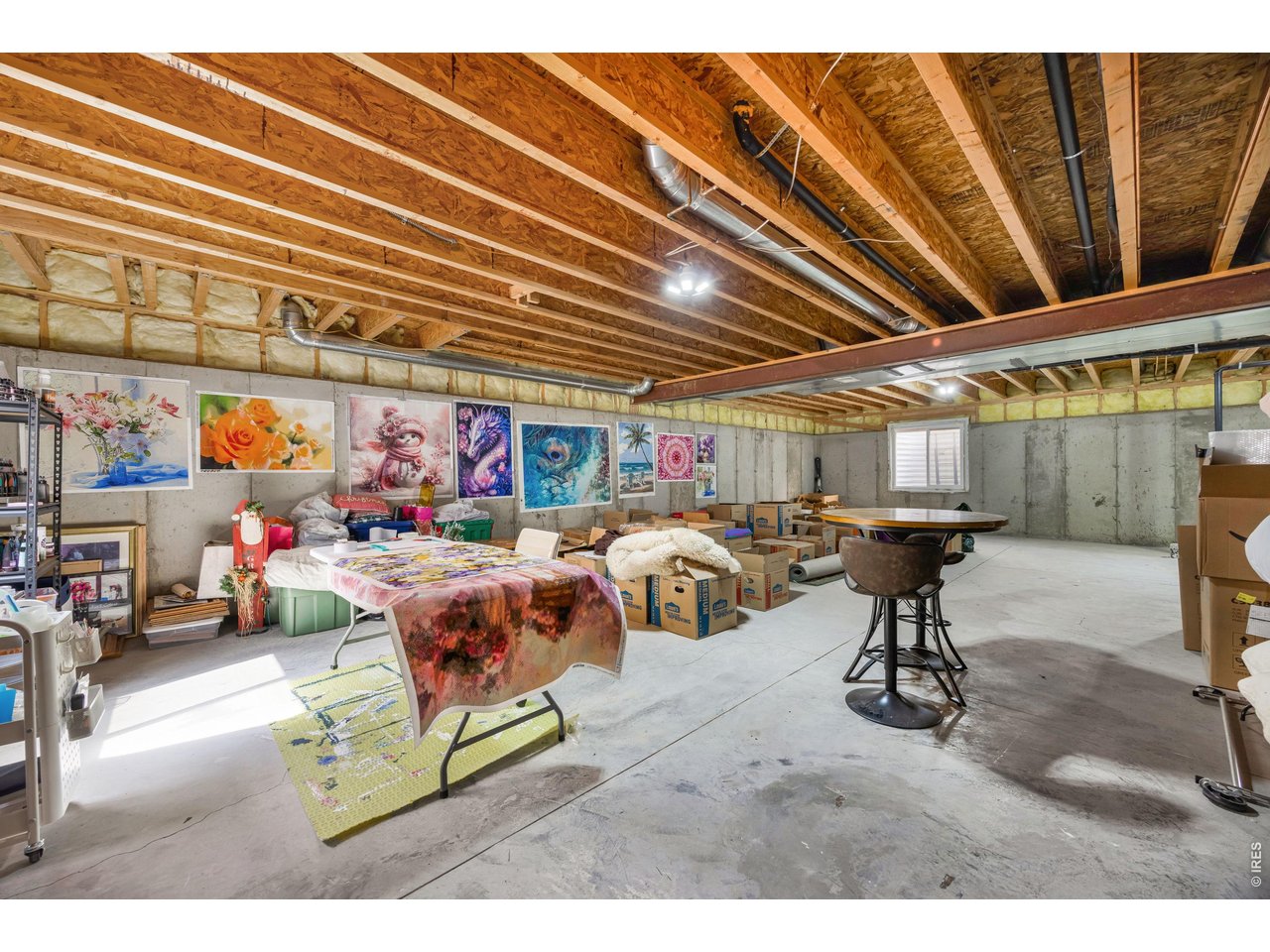 148 Beacon Way Windsor, CO 80550 - Photo 29 of 36 Expansive unfinished basement offering abundant storage, workshop space, or future finishing potential with natural light.