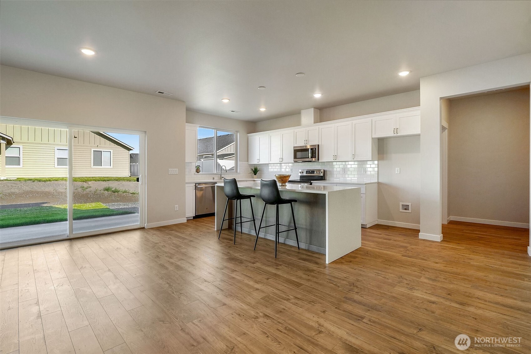 494 North Ruddy Street Moses Lake, WA 98837 - Photo 12 of 19 a kitchen with stainless steel appliances kitchen island wooden cabinets and granite counter tops