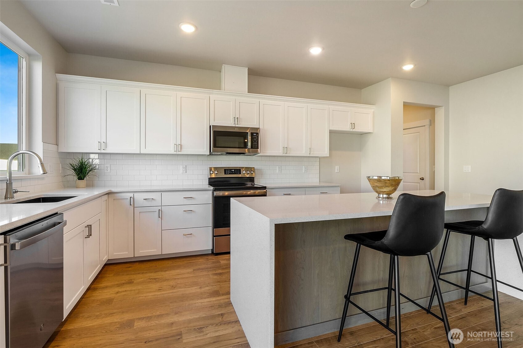 494 North Ruddy Street Moses Lake, WA 98837 - Photo 14 of 19 a kitchen with stainless steel appliances granite countertop a stove a sink a refrigerator and white cabinets