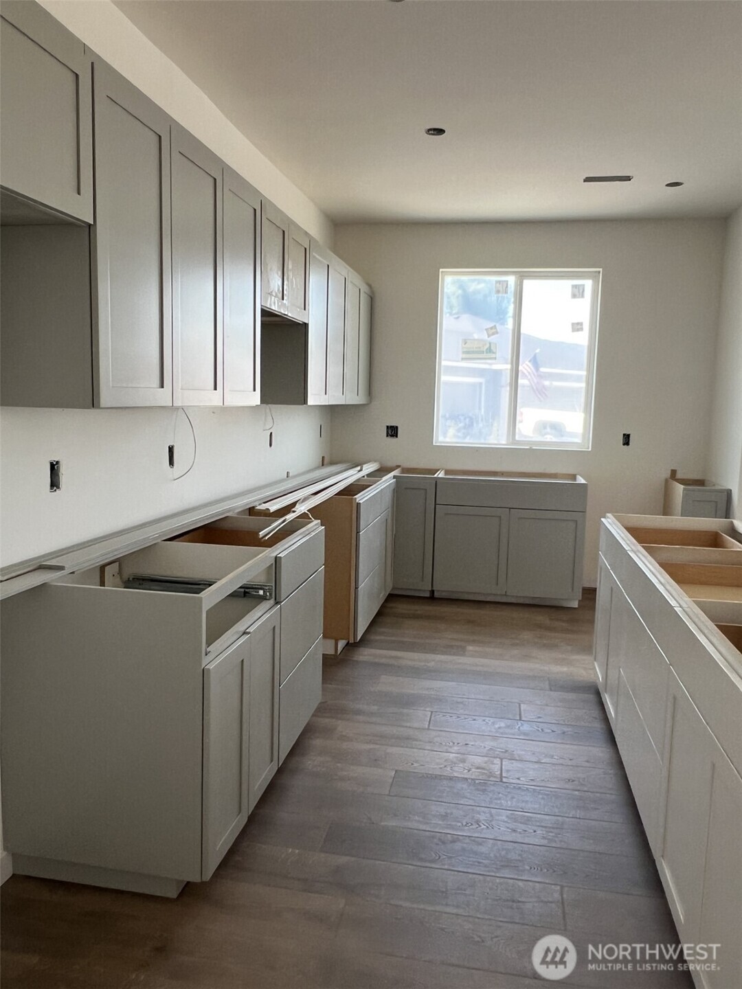 494 North Ruddy Street Moses Lake, WA 98837 - Photo 5 of 19 a large kitchen with stainless steel appliances granite countertop a sink and dishwasher a stove top oven with wooden floor
