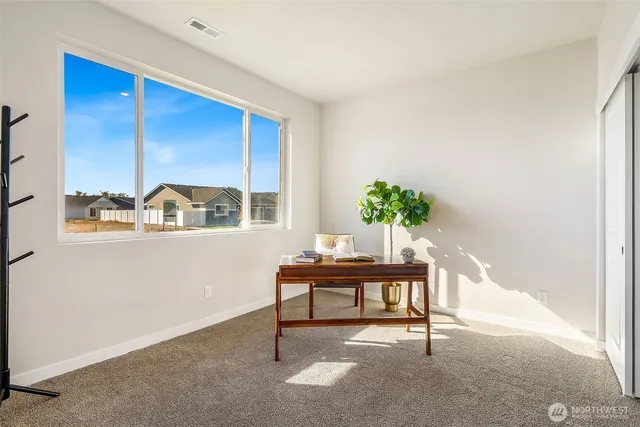 a spacious bedroom with a large bed and a couch