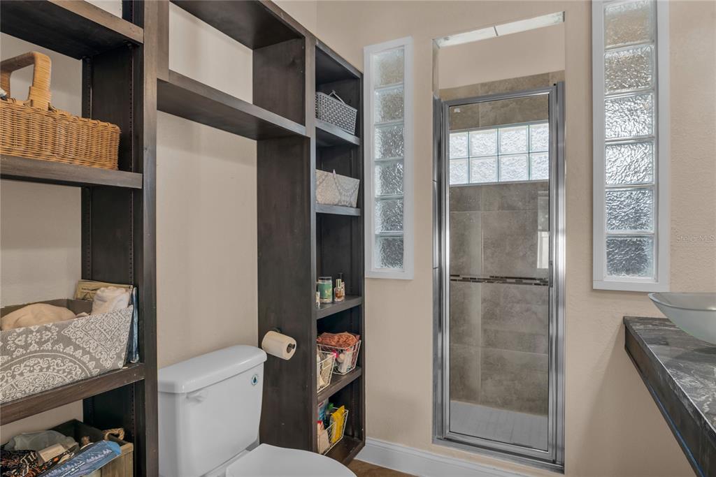 2414 Newberry Street Orlando, FL 32806 - Photo 19 of 36 a bathroom with a toilet and a shower