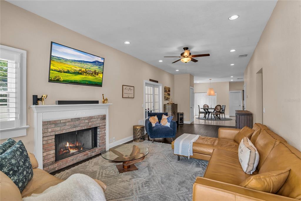 2414 Newberry Street Orlando, FL 32806 - Photo 2 of 36 a living room with furniture ceiling fan and a fireplace