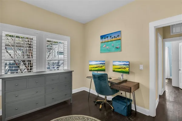 a view of a workspace with furniture and a window