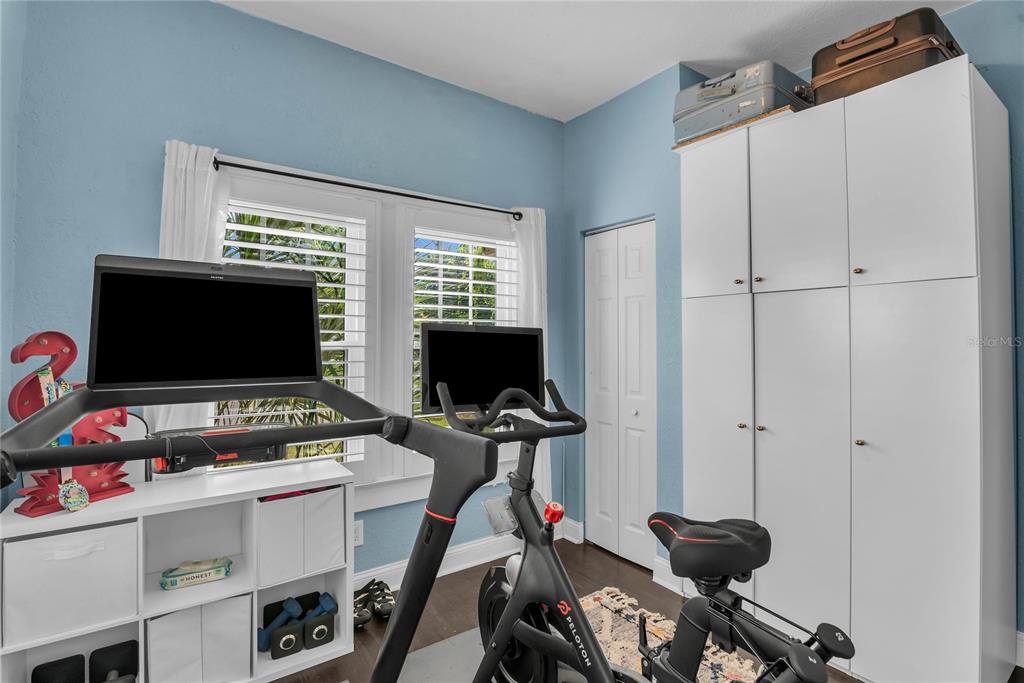 2414 Newberry Street Orlando, FL 32806 - Photo 25 of 36 a bedroom with furniture and a flat screen tv