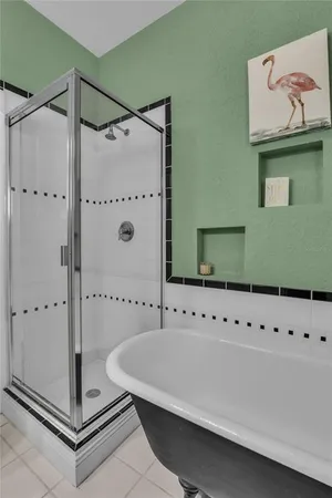 a bathroom with a shower and a mirror