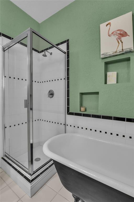 2414 Newberry Street Orlando, FL 32806 - Photo 27 of 36 a bathroom with a shower and a mirror