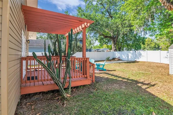 a view of a backyard with swimming pool and sitting area