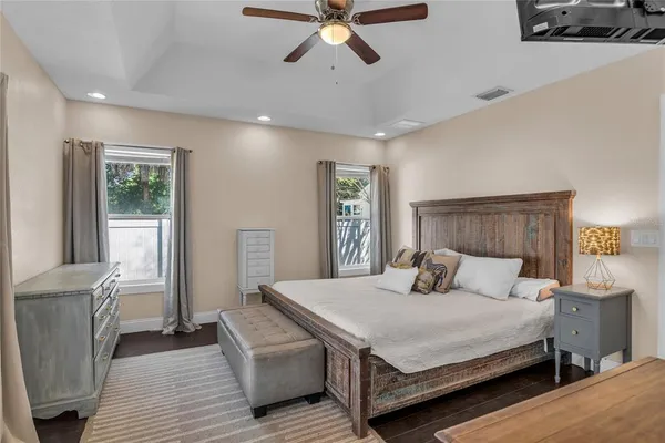a bedroom with a large bed and a chandelier