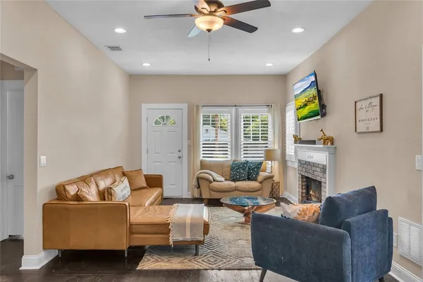 a living room with furniture fireplace and a flat screen tv