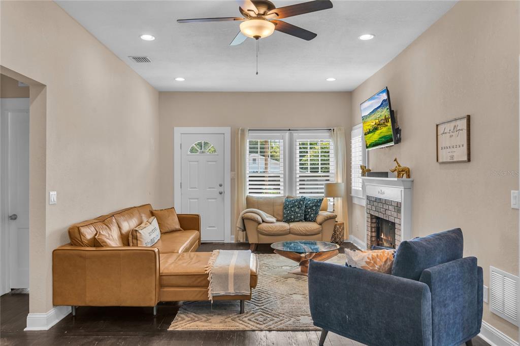 2414 Newberry Street Orlando, FL 32806 - Photo 7 of 36 a living room with furniture fireplace and a flat screen tv