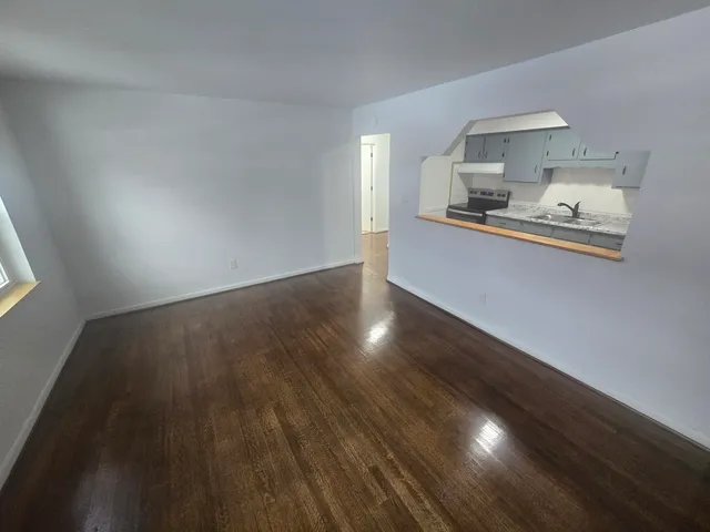 a kitchen with granite countertop a sink and cabinets