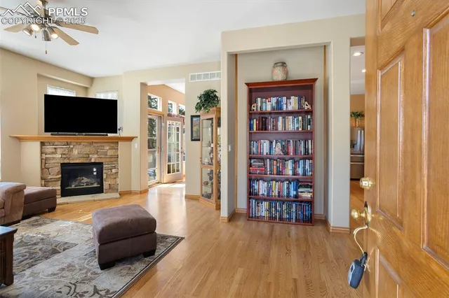 a living room with furniture a flat screen tv and a fireplace