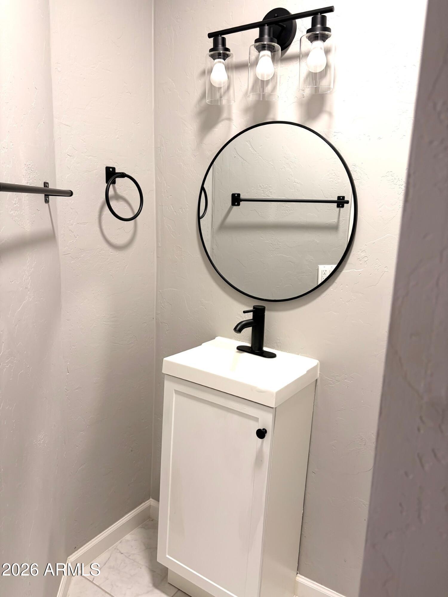 826 1st Street Douglas, AZ 85607 - Photo 22 of 35 a bathroom with a sink and mirror