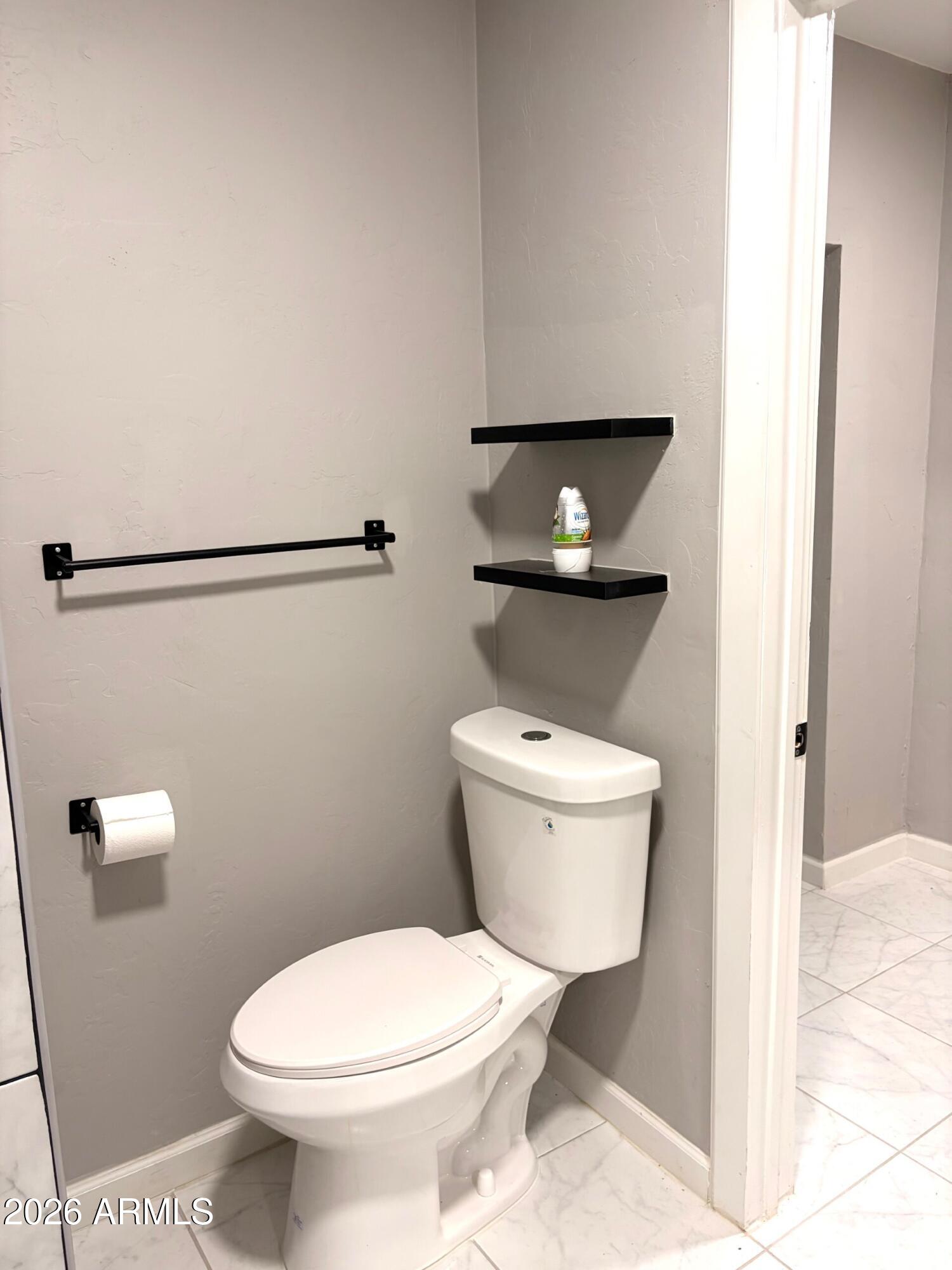 826 1st Street Douglas, AZ 85607 - Photo 25 of 35 a white toilet sitting next to a shower curtain