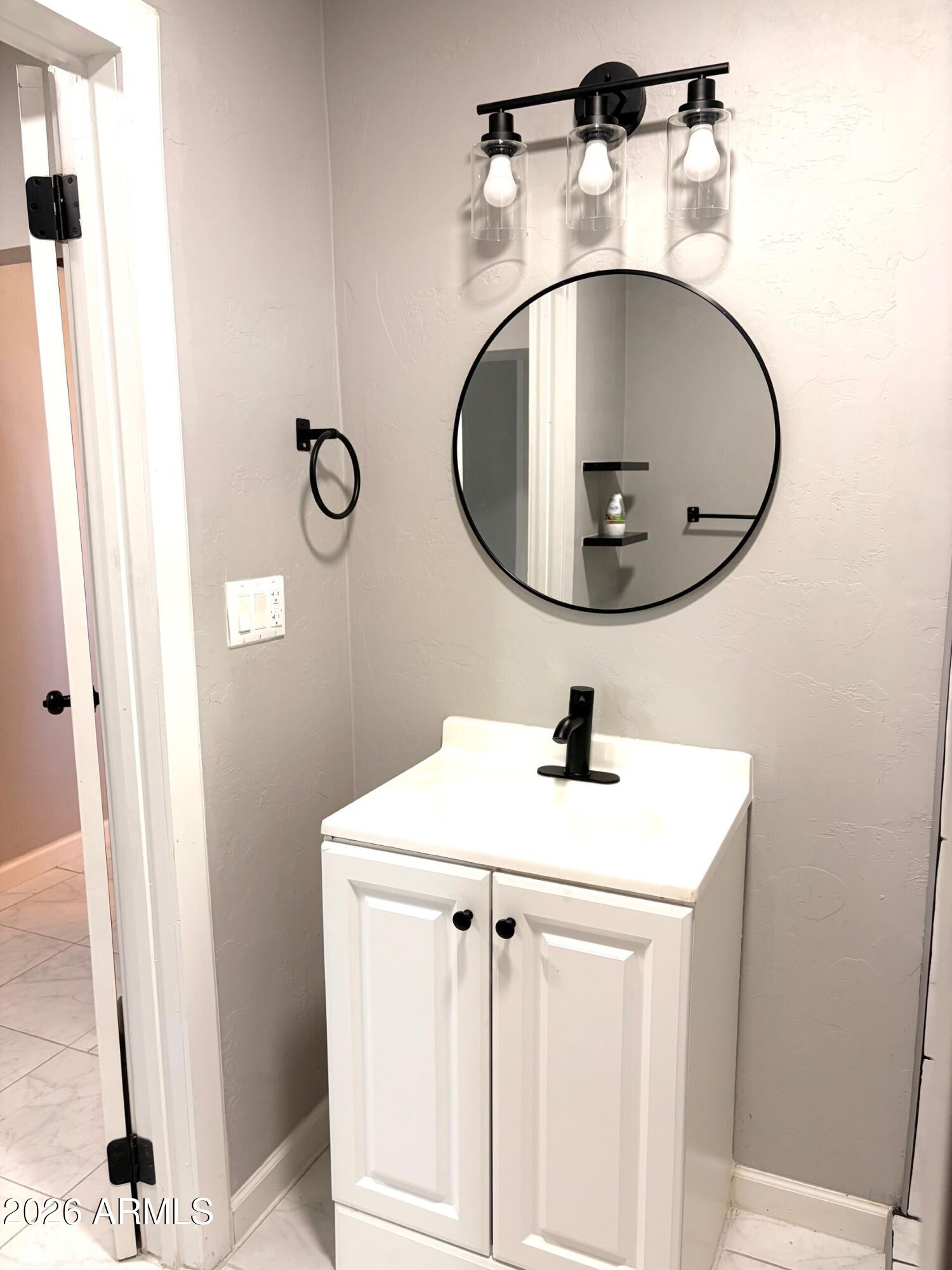 826 1st Street Douglas, AZ 85607 - Photo 27 of 35 a bathroom with a sink and a mirror