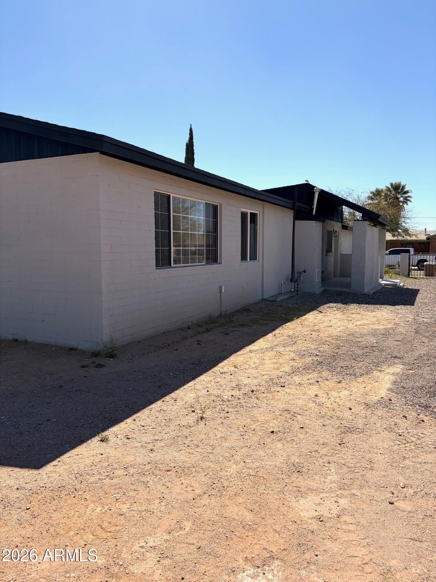 826 1st Street Douglas, AZ 85607 - Photo 35 of 35 a backyard of a house with wooden floor and fence