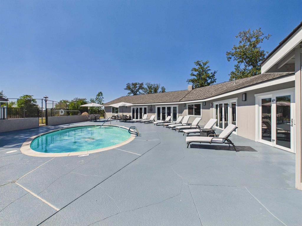 18218 Paradise Mountain Road, Unit 220 Valley Center, CA 92082 - Photo 11 of 48 a view of a house with swimming pool and sitting area