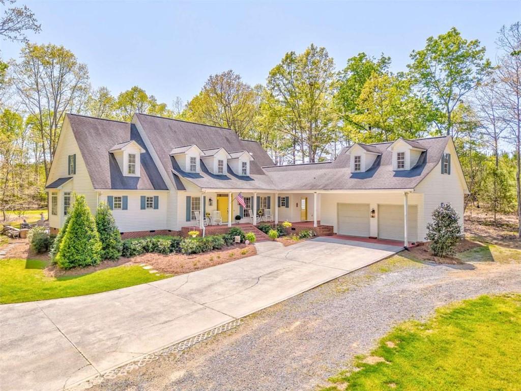 6095 Blacks Bluff Road Southwest Cave Spring, GA 30124 - Photo 1 of 1 a front view of a house with a yard and potted plants