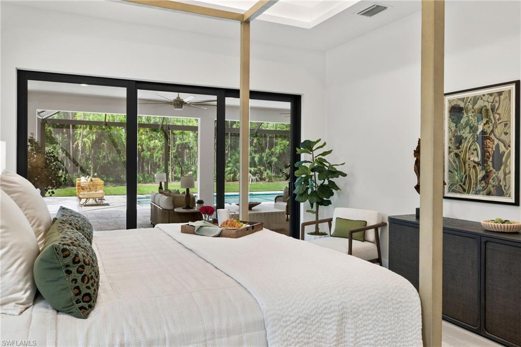 4221 7th Avenue Northwest Naples, FL 34119 - Photo 19 of 42 a large bed sitting in a bedroom next to a window