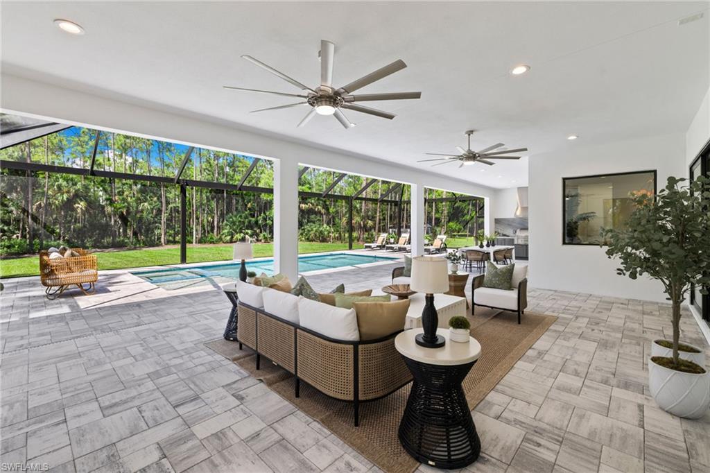 4221 7th Avenue Northwest Naples, FL 34119 - Photo 30 of 42 a living room with patio furniture and a floor to ceiling window