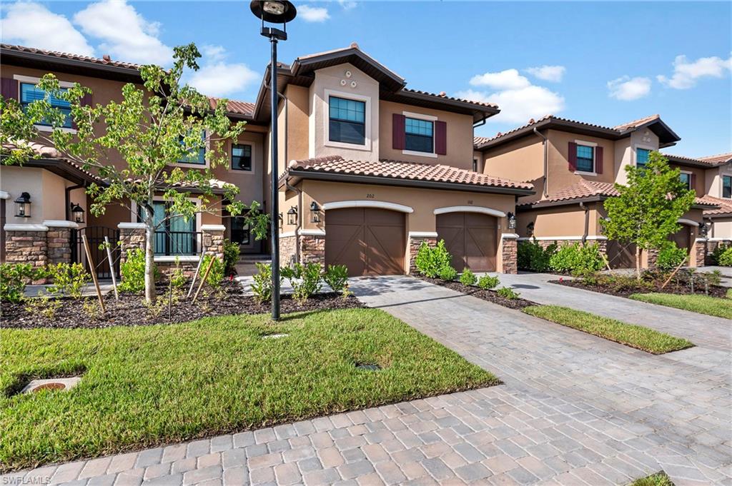 15328 Lucerna Street, Unit 202 Naples, FL 34114 - Photo 22 of 32 a view of a house with garden and plants