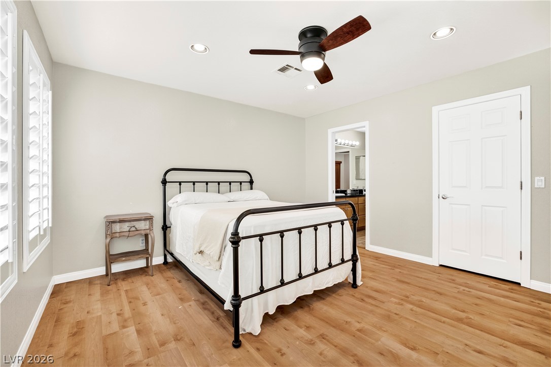 1135 Calico Ridge Drive Henderson, NV 89011 - Photo 39 of 86 A well-appointed bedroom features ample light, recessed fixtures, and rich wood-look flooring.