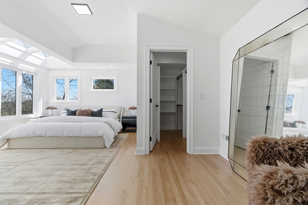 171 Shaw Road Brookline, MA 02467 - Photo 28 of 42 a spacious bedroom with a bed and a large mirror
