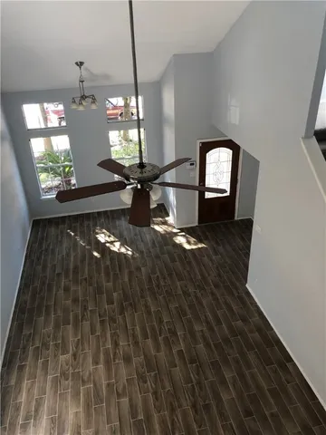 a room with lots of light fixtures and a wooden floor