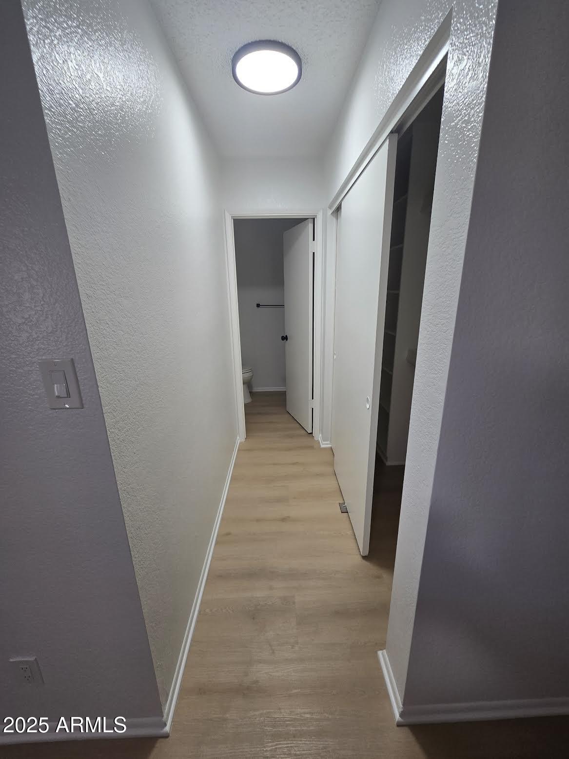 97 North Cooper Road, Unit 86 Chandler, AZ 85225 - Photo 11 of 16 a view of a hallway with wooden floor