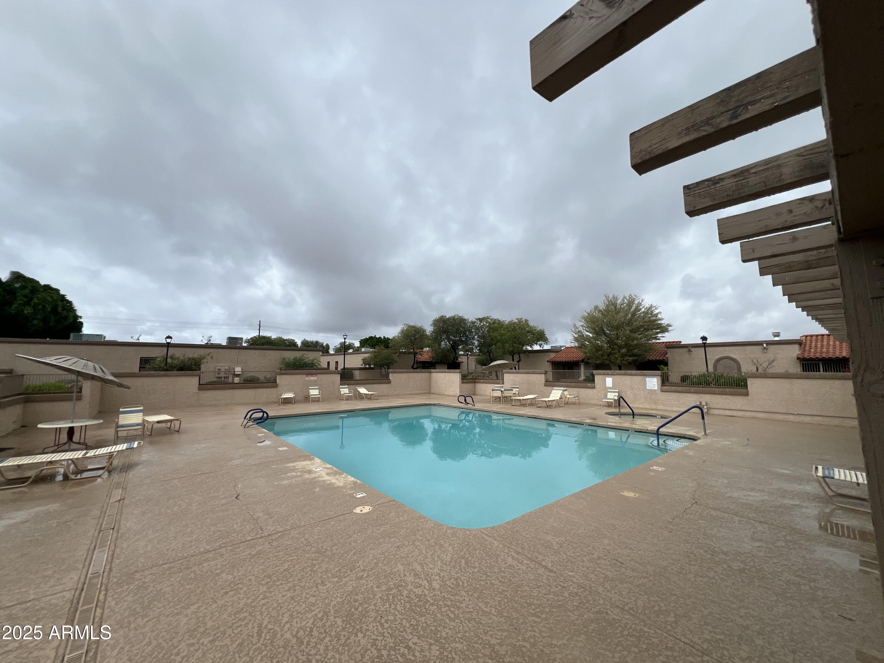 97 North Cooper Road, Unit 86 Chandler, AZ 85225 - Photo 14 of 16 an outdoor space with swimming pool and furniture