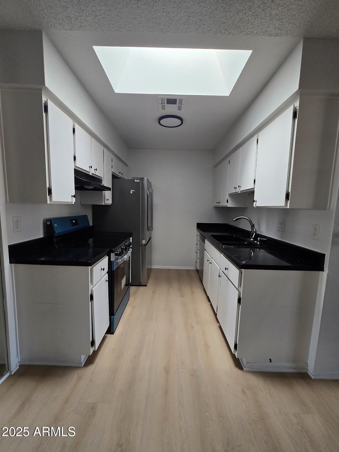 97 North Cooper Road, Unit 86 Chandler, AZ 85225 - Photo 2 of 16 a kitchen with stainless steel appliances a sink dishwasher stove and cabinets